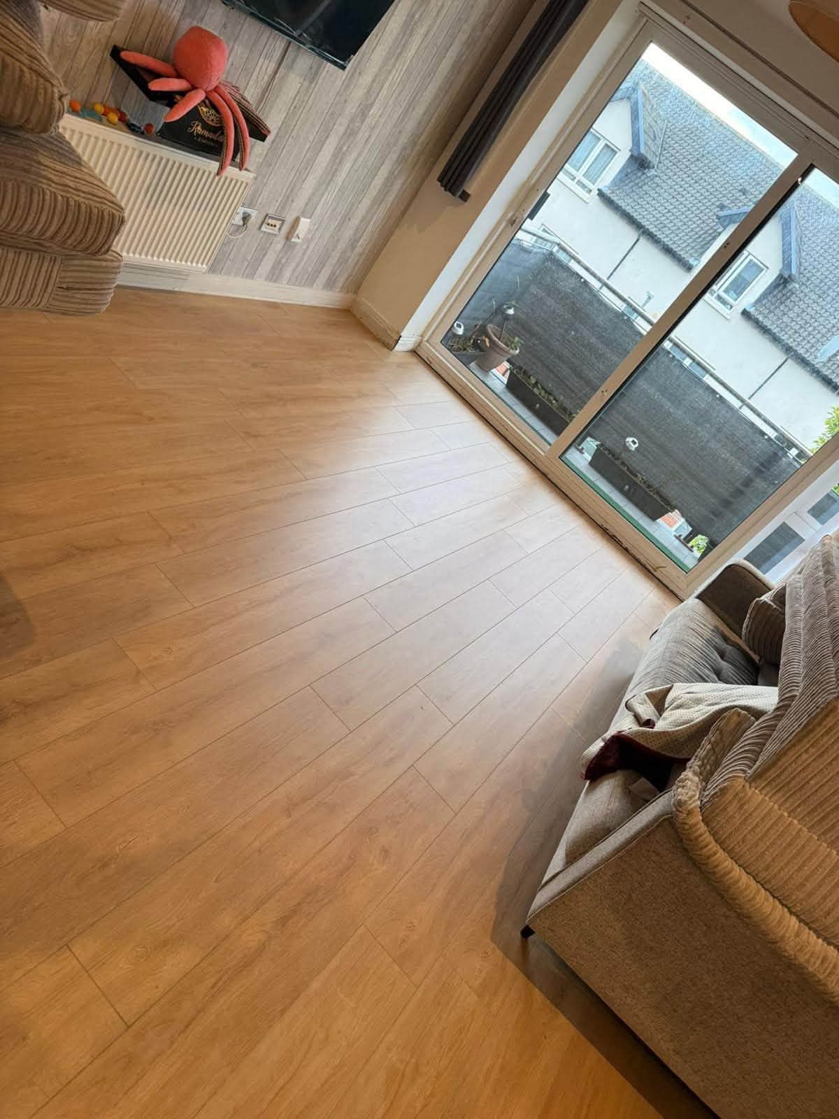 Finished light wood-effect flooring in a bright living room