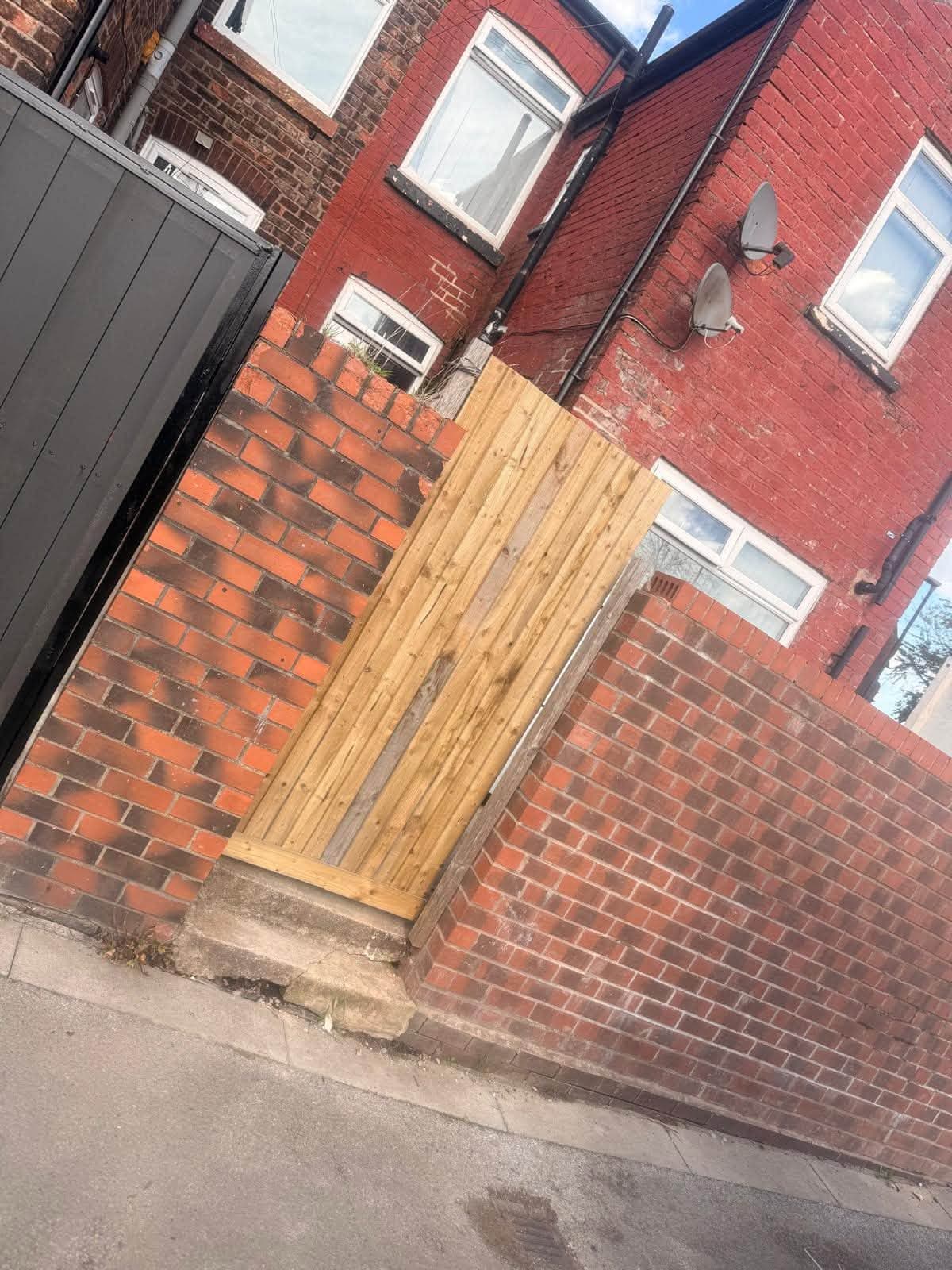 New timber side gate fitted between brick walls