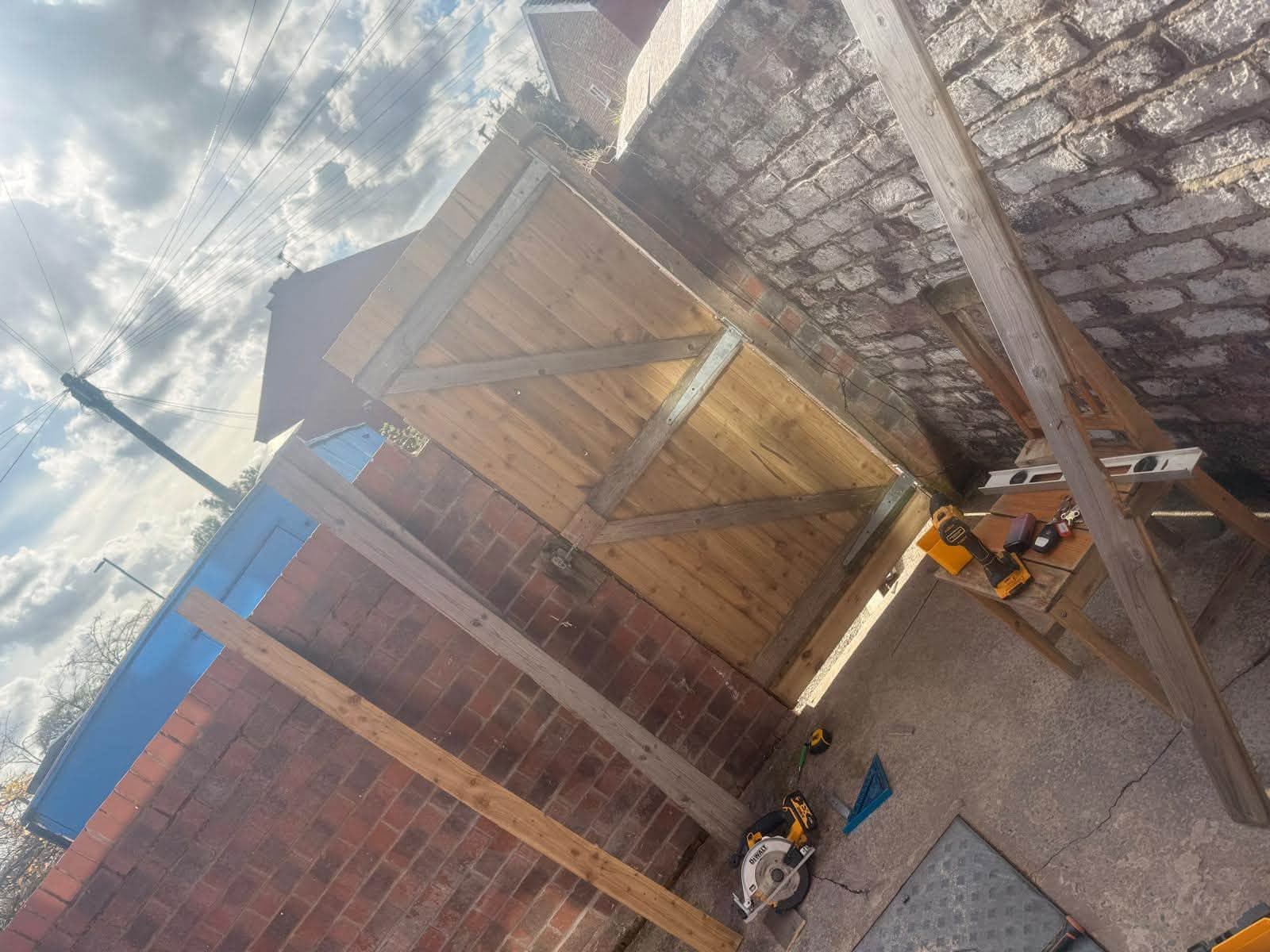 Timber garden fencing being constructed with tools nearby