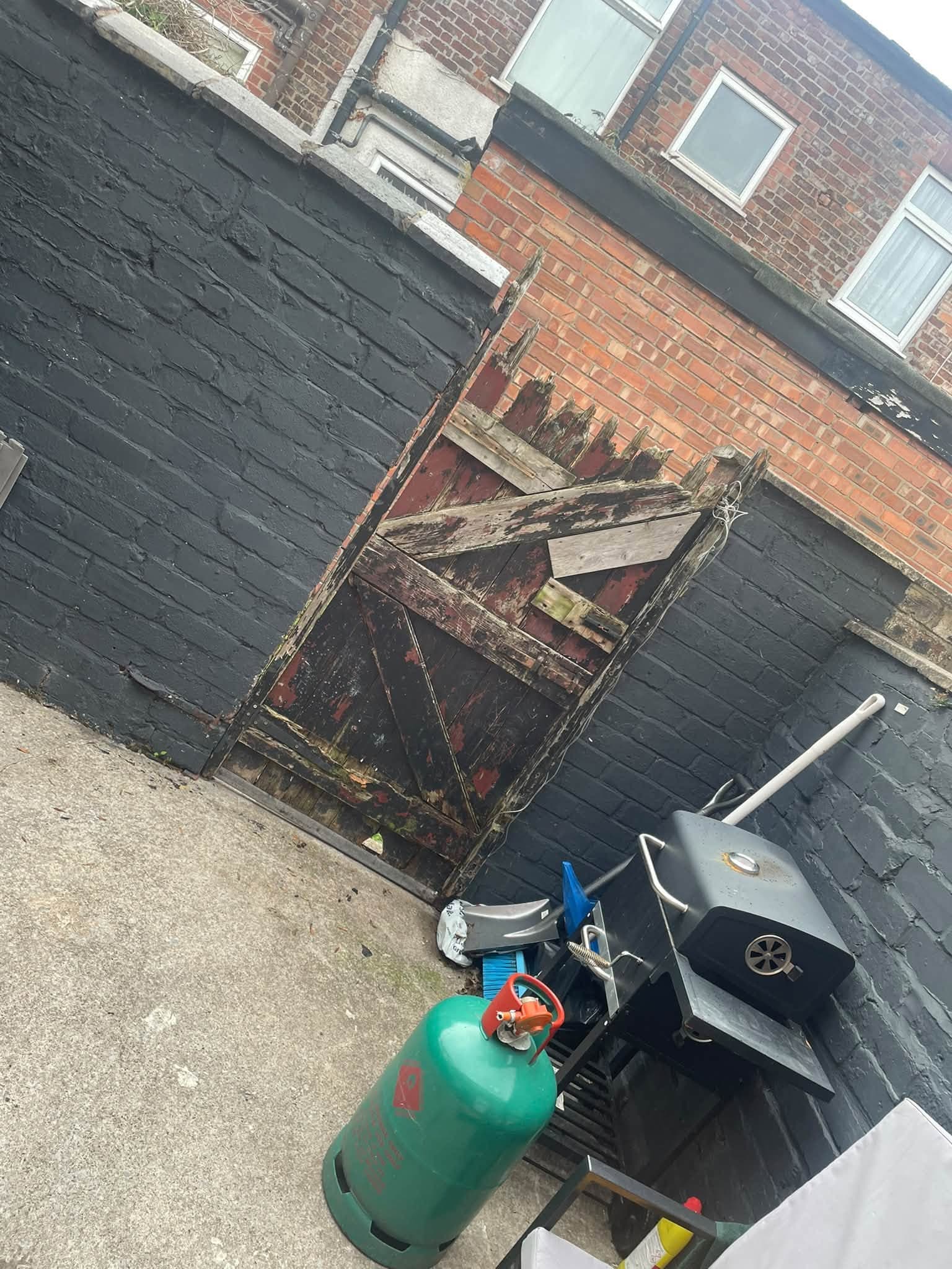 Weathered timber garden gate before replacement
