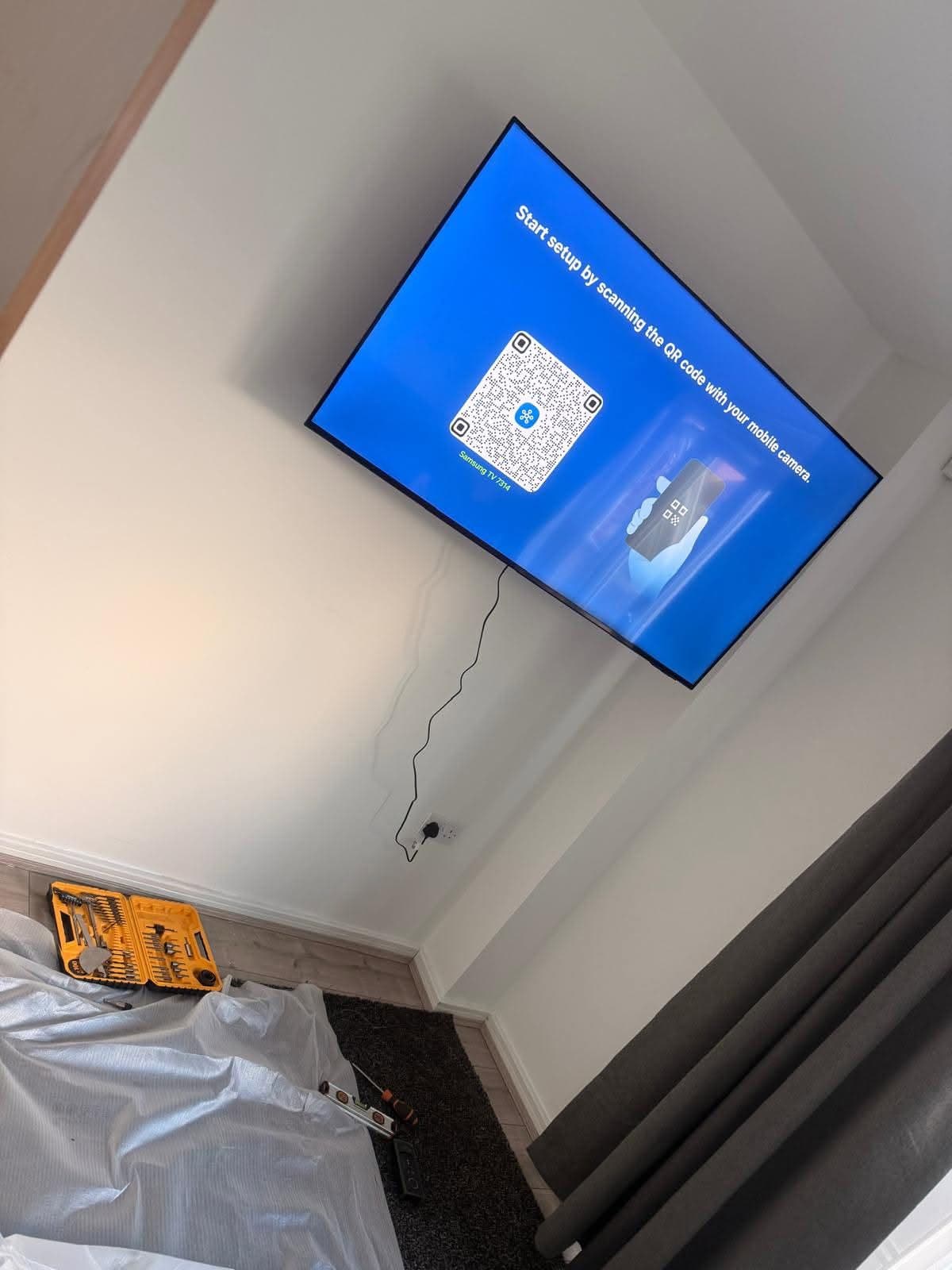 A television fitted to a living room wall