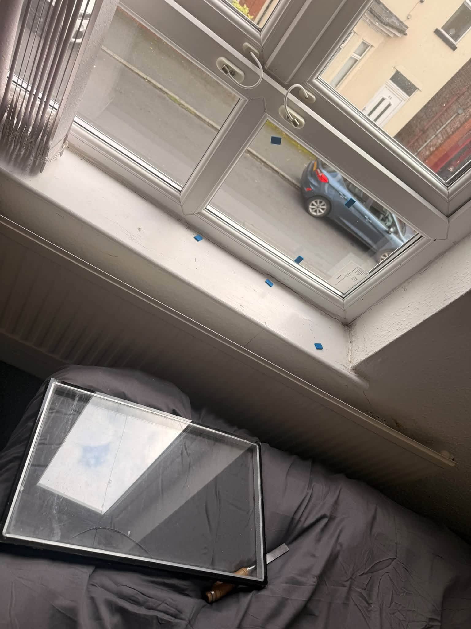 Replacement white window unit being prepared indoors